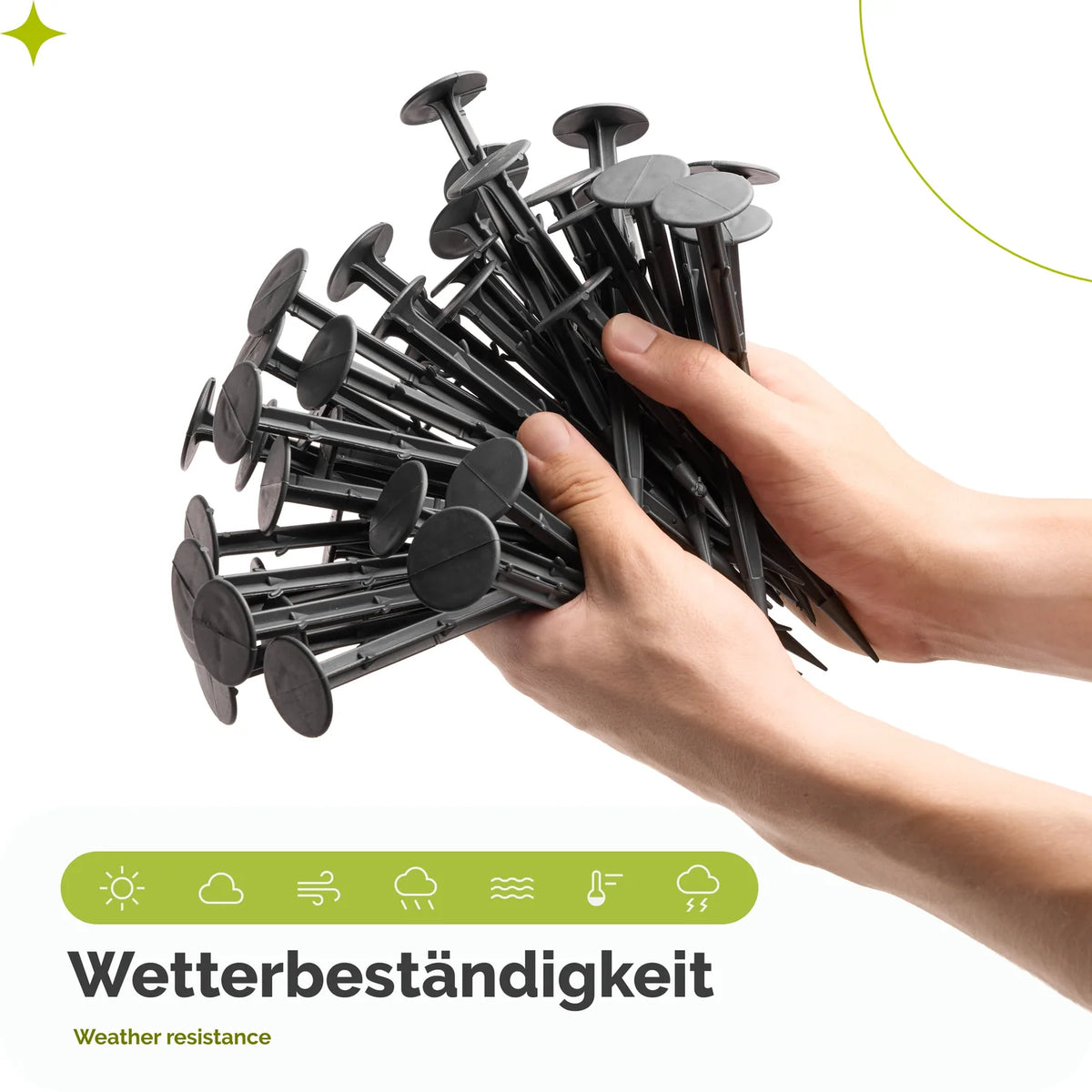 Hände halten 50 schwarze Erdanker aus Kunststoff – wetterbeständige Bodenanker für den Garten